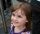Image:  Smiling young girl with purple top