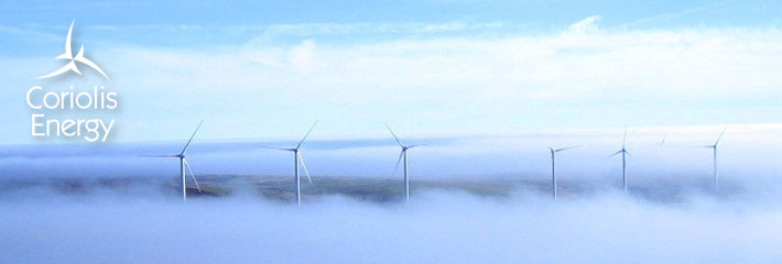 Image: Group of six wind turbines in a foggy landscape